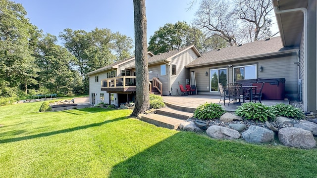 rear view of property featuring a deck, a yard, a patio area, and a trampoline