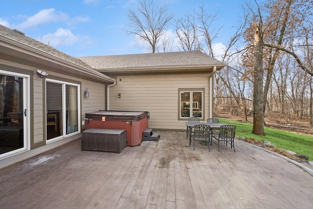 deck with a lawn, a hot tub, outdoor dining area, and a patio