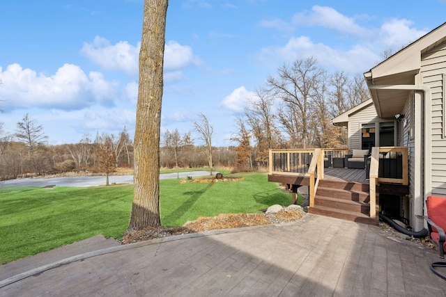 view of yard featuring a deck with water view