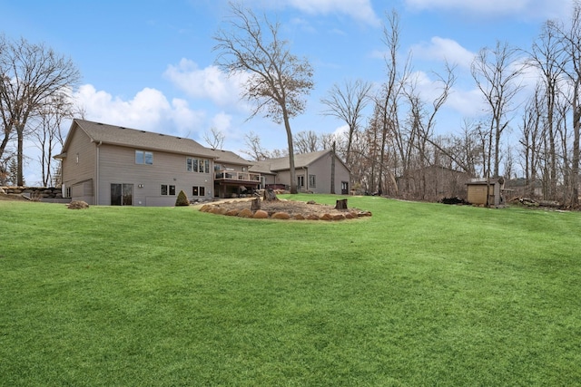 view of yard featuring a deck and an attached garage