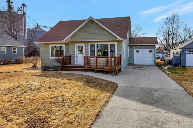 view of front facade with a garage, concrete driveway, and a shingled roof