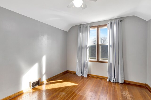 bonus room with visible vents, vaulted ceiling, baseboards, and hardwood / wood-style flooring