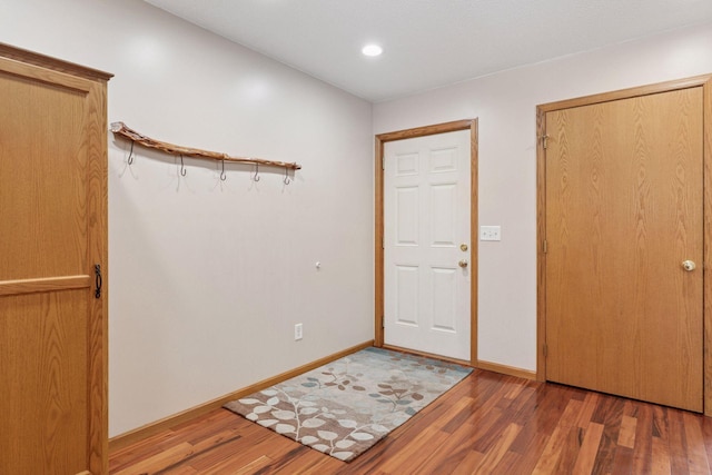 foyer with light wood-style floors and baseboards