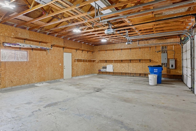 garage with electric panel and a garage door opener