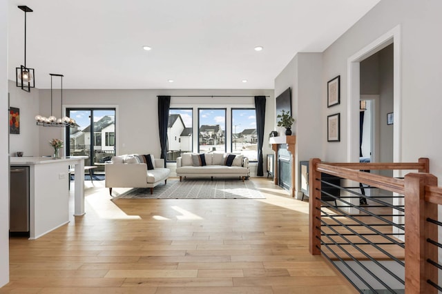 living room featuring a healthy amount of sunlight, recessed lighting, and light wood-style floors