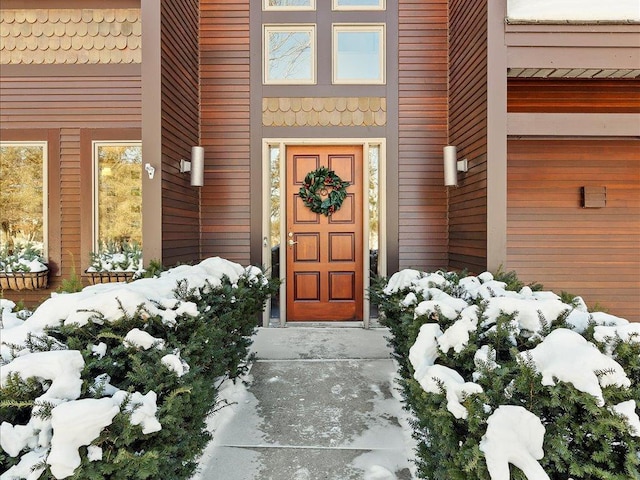 view of snow covered property entrance