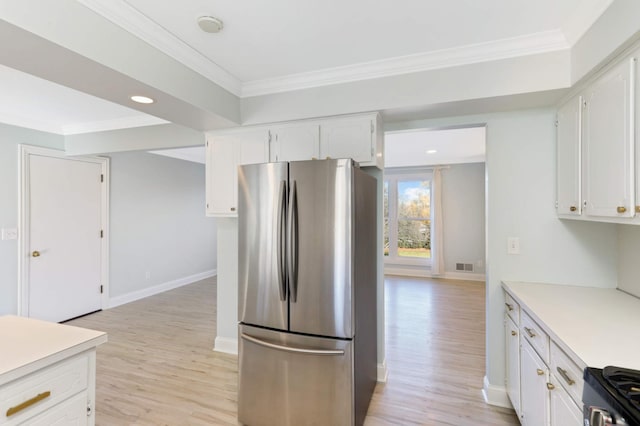 kitchen with light wood-type flooring, light countertops, white cabinetry, and appliances with stainless steel finishes