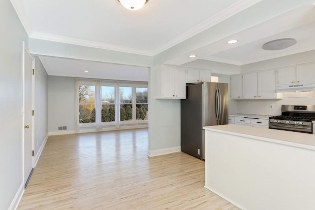 kitchen featuring crown molding, light wood-type flooring, baseboards, under cabinet range hood, and stainless steel appliances
