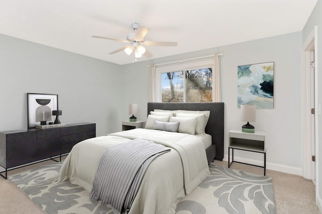 bedroom with baseboards, light colored carpet, and ceiling fan
