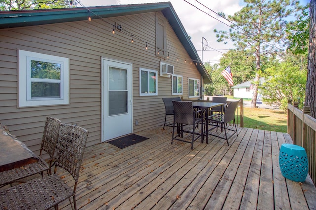 deck featuring outdoor dining area and a wall mounted AC