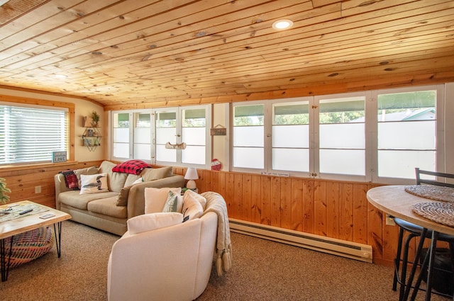 carpeted living area with a baseboard heating unit, wooden ceiling, and wooden walls