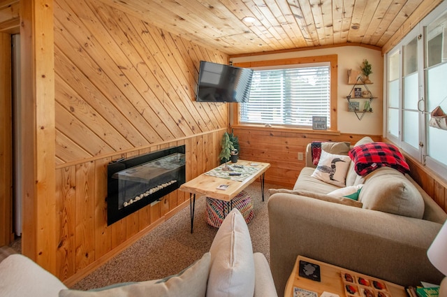 living area featuring wood ceiling, wood walls, a fireplace, and vaulted ceiling