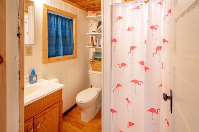 full bathroom featuring toilet, curtained shower, vanity, and wood finished floors