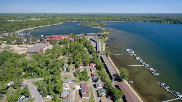 aerial view with a forest view and a water view