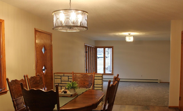 dining area with a chandelier, a baseboard radiator, and wood finished floors