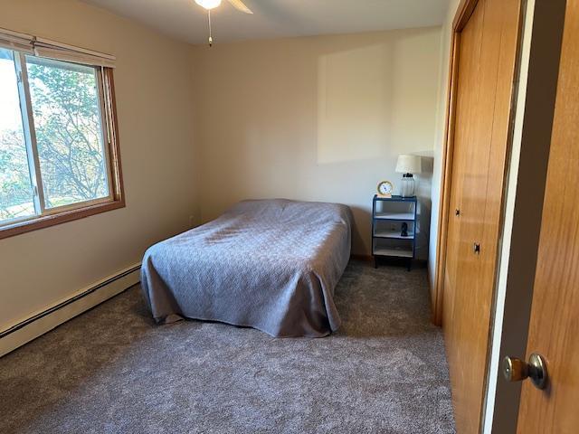 bedroom featuring carpet flooring and baseboard heating