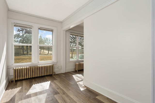 unfurnished sunroom featuring radiator heating unit