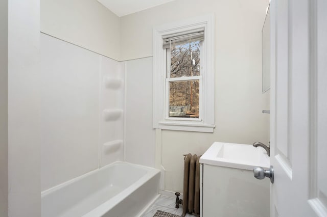 bathroom featuring washtub / shower combination and vanity