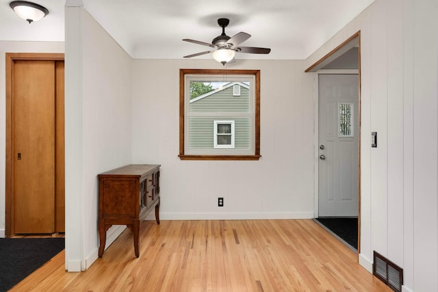 6719 Ewing Ave N, Brooklyn Center, MN 55429 - foyer featuring light wood finished floors, baseboards, and a ceiling fan