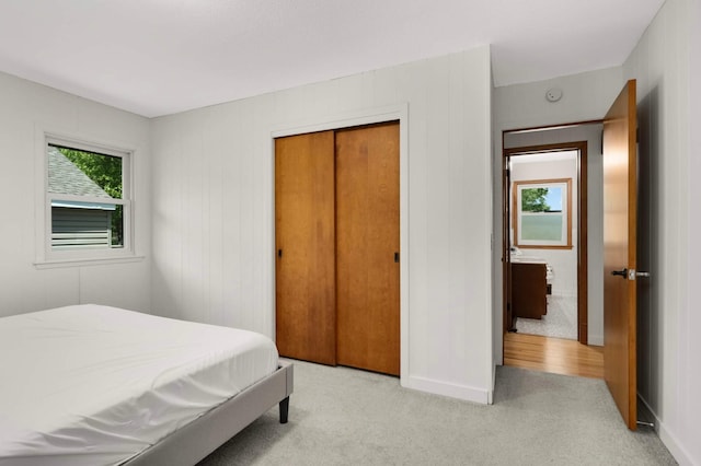 6719 Ewing Ave N, Brooklyn Center, MN 55429 - bedroom featuring light colored carpet, baseboards, and a closet