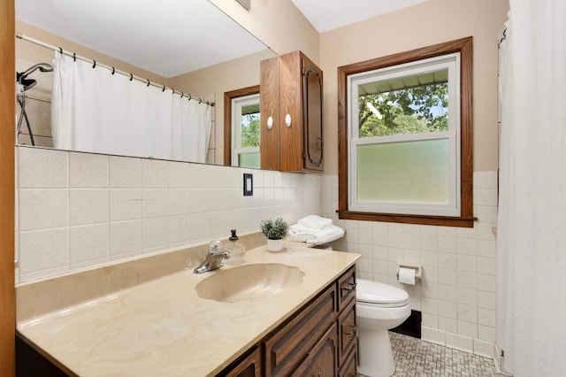 6719 Ewing Ave N, Brooklyn Center, MN 55429 - bathroom featuring tile walls, vanity, tile patterned floors, toilet, and curtained shower