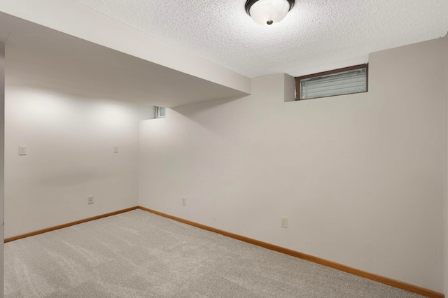6719 Ewing Ave N, Brooklyn Center, MN 55429 - finished basement featuring a textured ceiling, carpet flooring, and baseboards