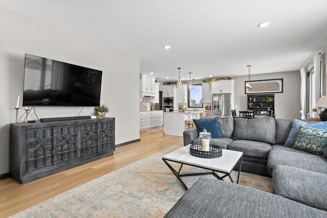 living area with recessed lighting and light wood-type flooring