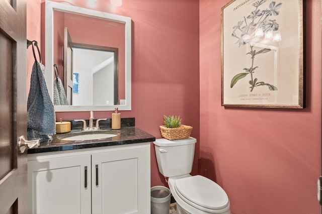 bathroom featuring toilet and vanity