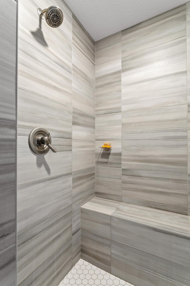 bathroom with a tile shower and a sauna