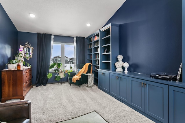 living area with recessed lighting and carpet