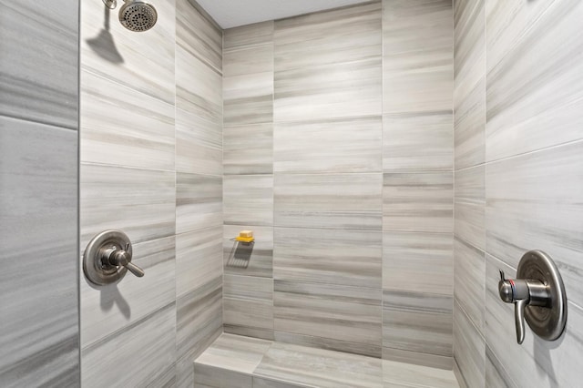 bathroom with tiled shower