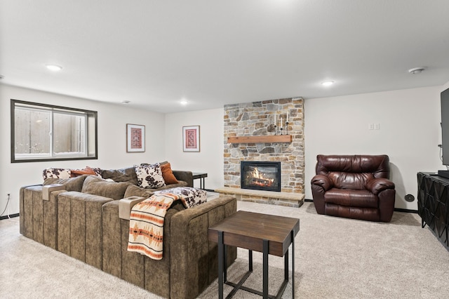 living room featuring a stone fireplace, carpet flooring, and recessed lighting