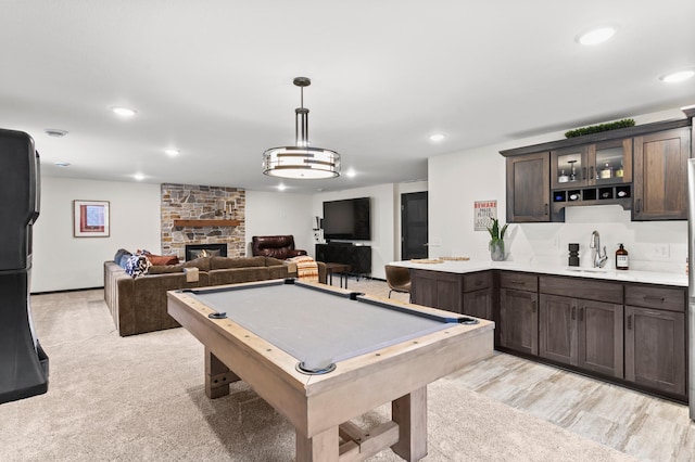 game room featuring a sink, billiards, a stone fireplace, and recessed lighting