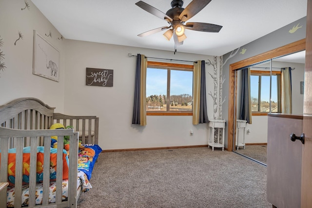 bedroom featuring a ceiling fan, multiple windows, baseboards, and carpet flooring