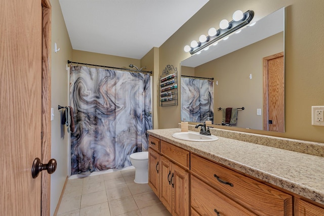 bathroom with toilet, tile patterned flooring, and vanity