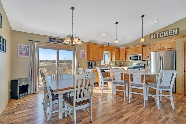 dining space with vaulted ceiling, light wood finished floors, a chandelier, and recessed lighting