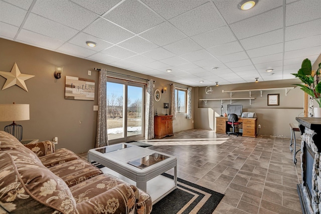 living room featuring a paneled ceiling