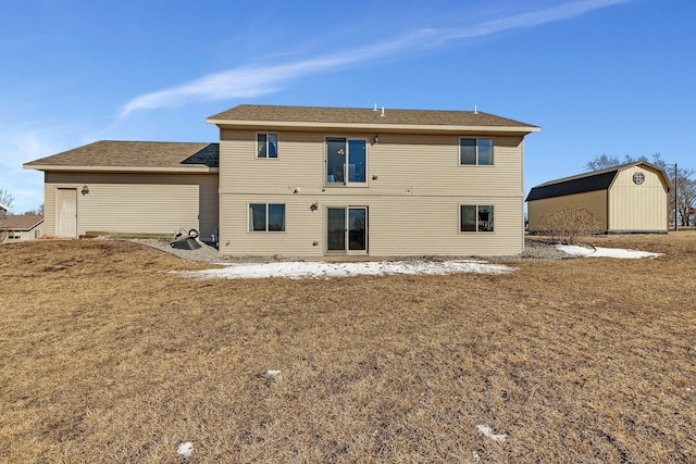 rear view of property featuring an outbuilding