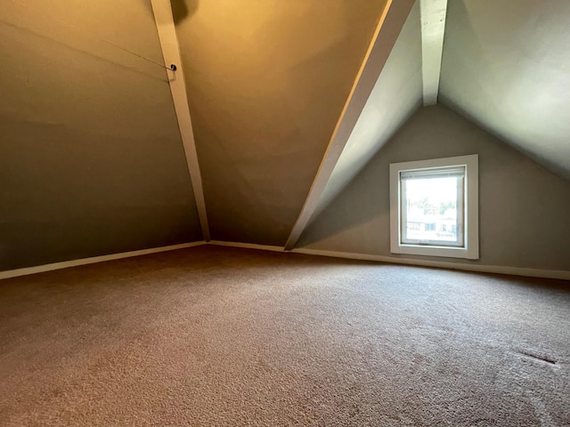 additional living space featuring vaulted ceiling, baseboards, and carpet floors