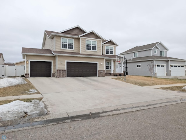 craftsman house featuring concrete driveway, brick siding, fence, and a gate