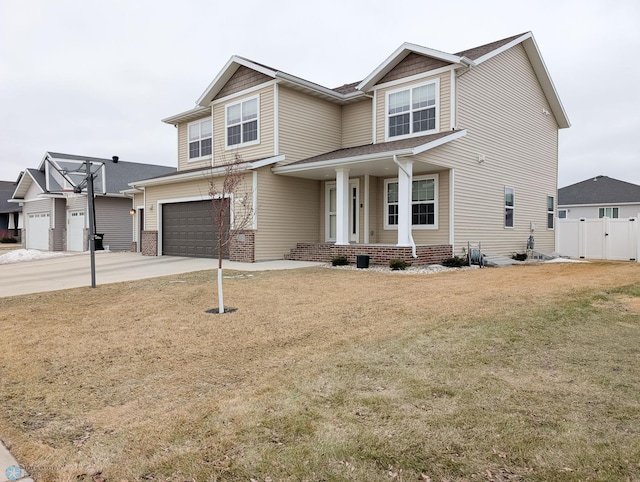 view of front facade with a garage, fence, concrete driveway, and a front yard