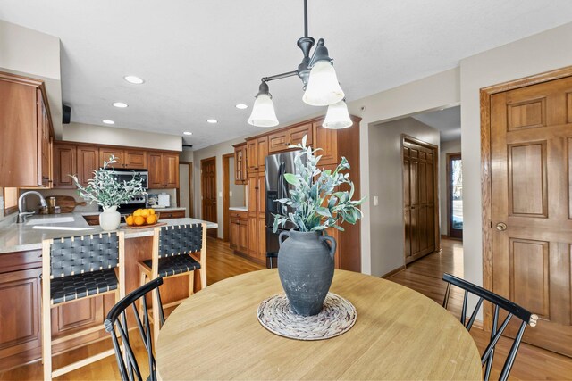 dining space with recessed lighting and light wood-style floors