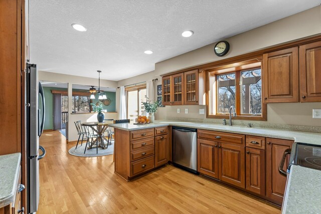 kitchen with a sink, brown cabinets, and appliances with stainless steel finishes