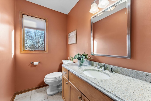 bathroom with tile patterned floors, toilet, vanity, and baseboards