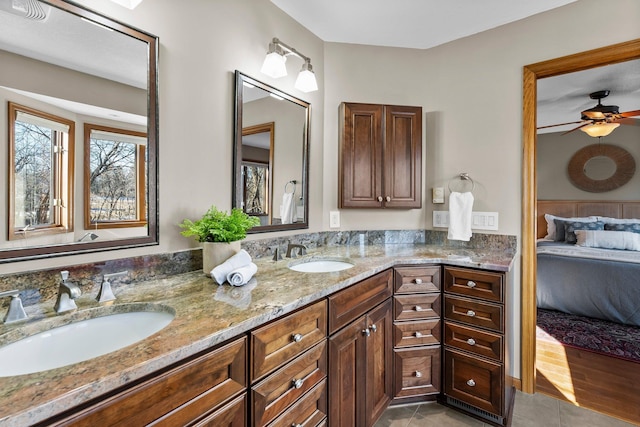 full bath featuring ensuite bath, double vanity, tile patterned floors, and a sink