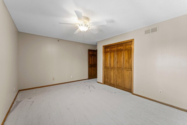 unfurnished bedroom with a closet, visible vents, a ceiling fan, and baseboards