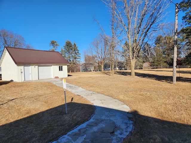 view of yard with a garage and an outdoor structure