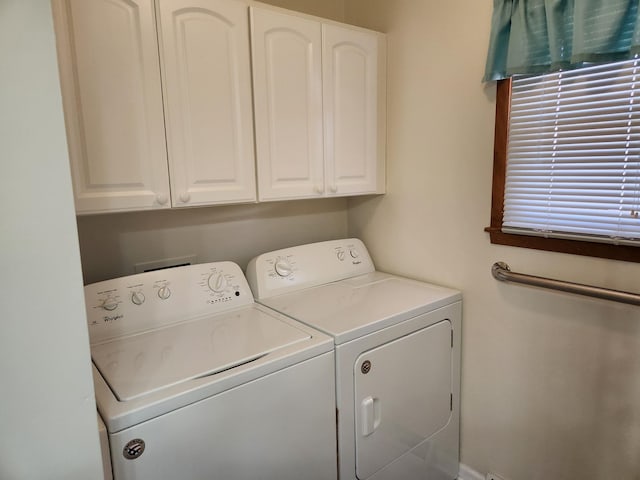 washroom with cabinet space and washing machine and clothes dryer