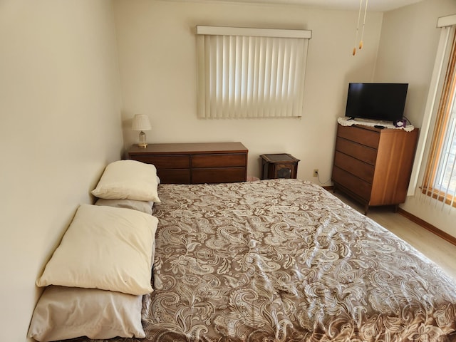 bedroom with baseboards and wood finished floors