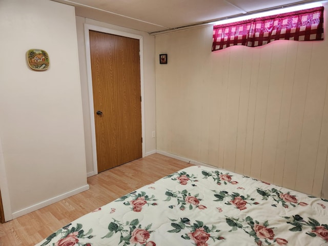 bedroom with baseboards and wood finished floors